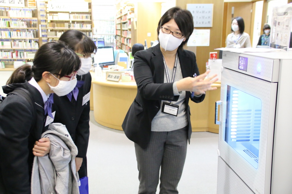 図書除菌機の見学をする生徒ら