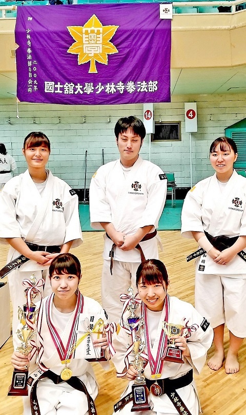 優勝トロフィーを掲げる山内選手(前列左)と高橋選手