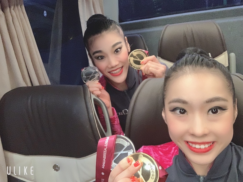 史上初の金メダルと団体総合では44年ぶりの銀メダルを掲げる横田選手(手前)と松原選手