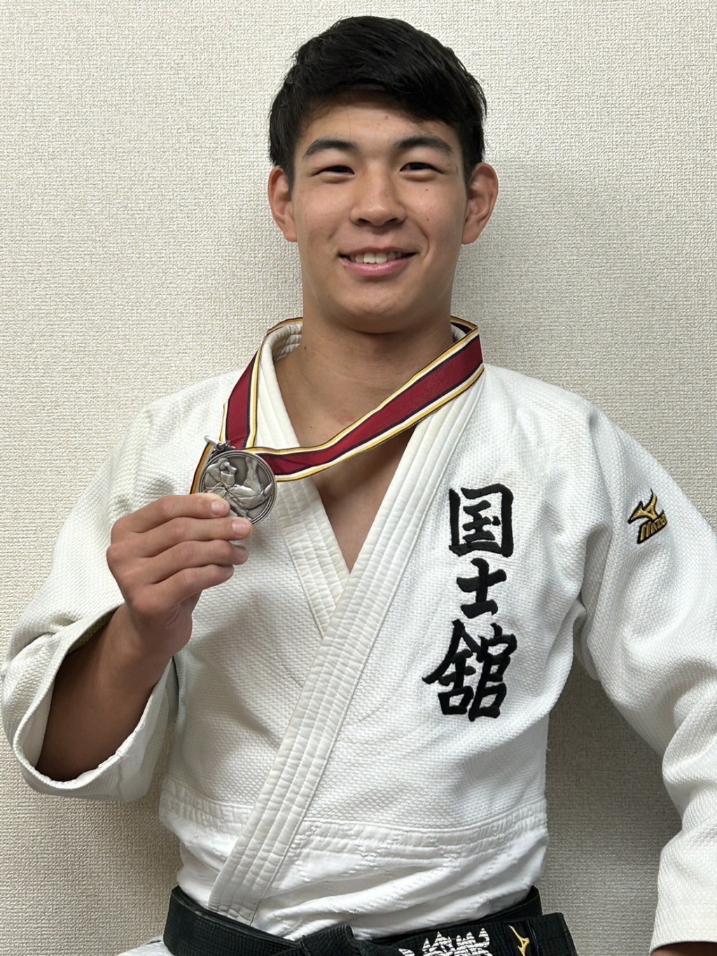 メダルを手に笑顔を見せる竹市選手