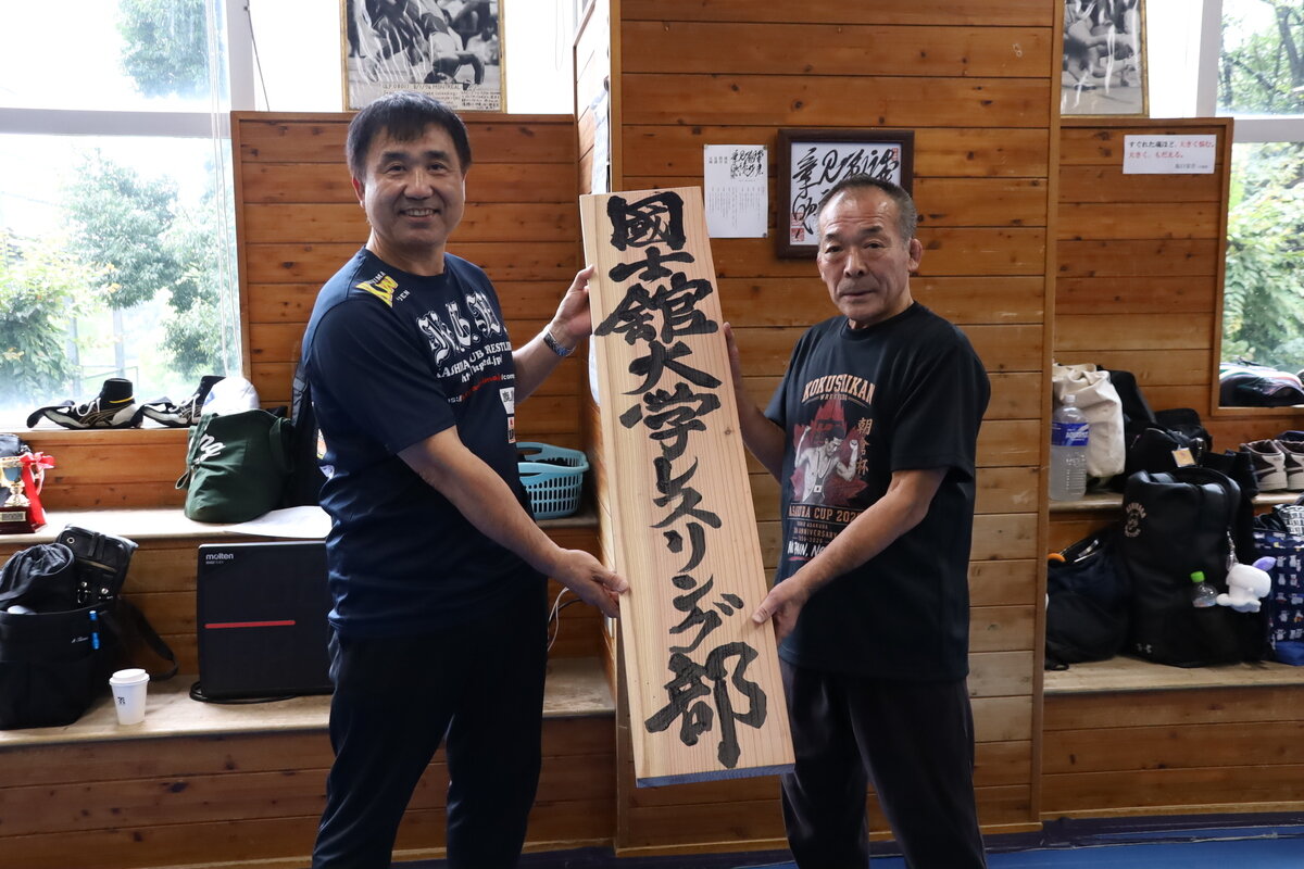 高野氏(左)より寄贈された看板